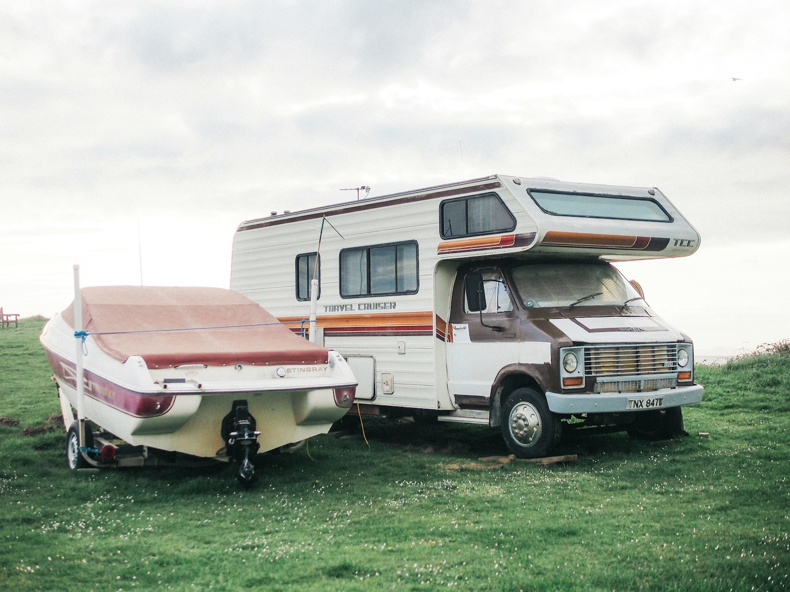 a motor home is parked next to a trailer